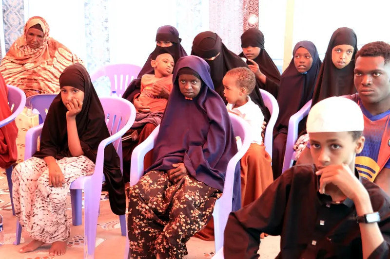 Families seated together under the tent