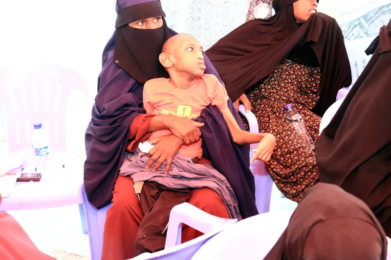 A mother holding her son at the gathering